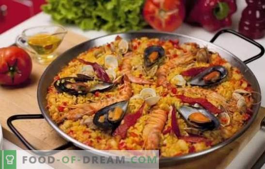 Paella con mariscos - plov en estilo español. Cocinando paella con mariscos y frijoles, maíz, guisantes, pescado